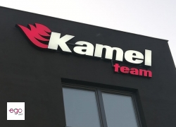 logo-swiecace-na-ciemnej elewacji-kamel-team-lublin